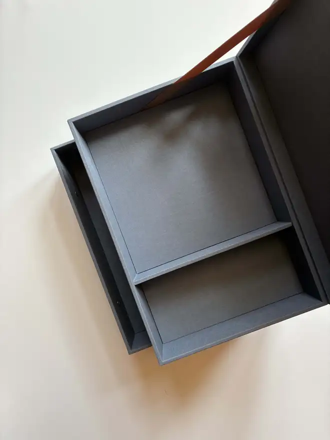 Open and empty tiered wedding keepsake box with drawer, compartments and ribbon detail