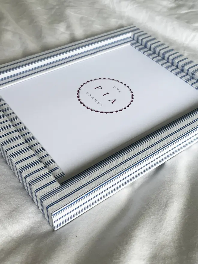 Rustic Blue Stripe Frame, a striped colourful frame sitting on a plain white surface. 
