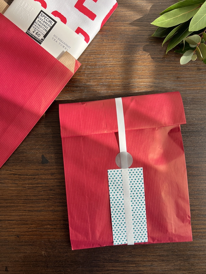 Optional gift wrap of red paper and white ribbon