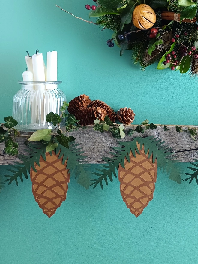 Pinecone Christmas Bunting displayed on wooden mantelpiece