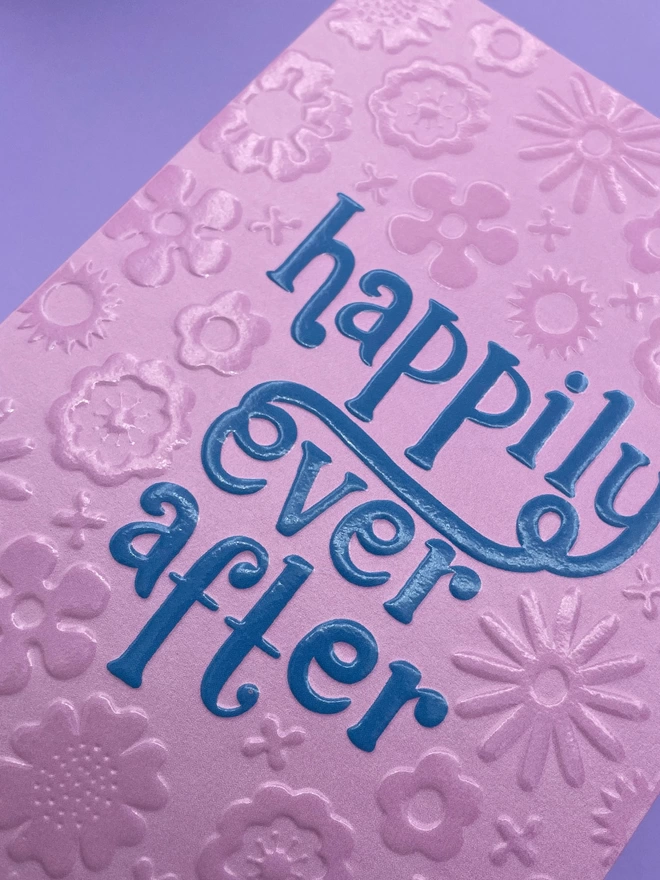 Detailed image of the spot UV and emboss finish that really enhances the Raspberry Blossom greetings card design  