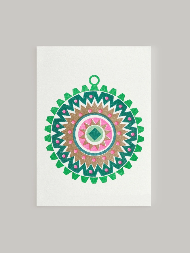 Retro Nordic influences are clear to see in this mini risograph printed Christmas card. This cute little bauble is full of festive cheer with highlights of metallic gold and fluro pink ink this is a modern way to send messages and festive greetings.