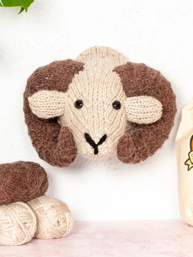 Ram Head Knit Kit. A large ram head in cream and brown.