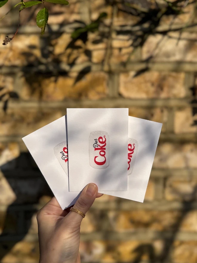 diet coke can illustrated mini cards (pack of 3). card set photographed against brick wall backdrop.