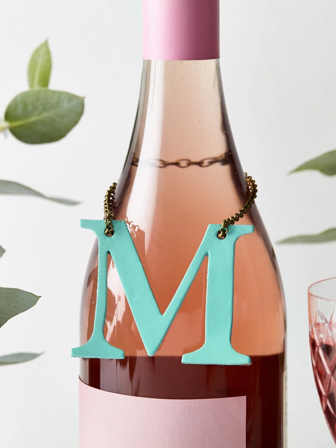 Mint Green Leather letter, M on a bottle of rose wine.