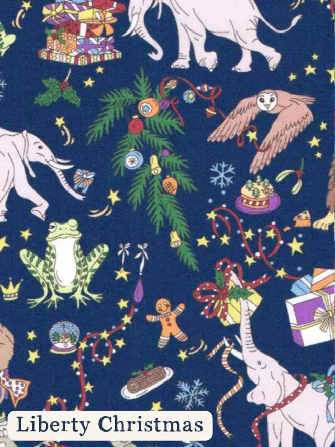 Liberty Christmas print featuring presents, elephants, monkeys in crowns and christmas holly 