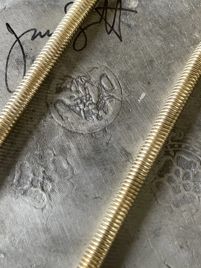 detail of makers mark on pewter plate