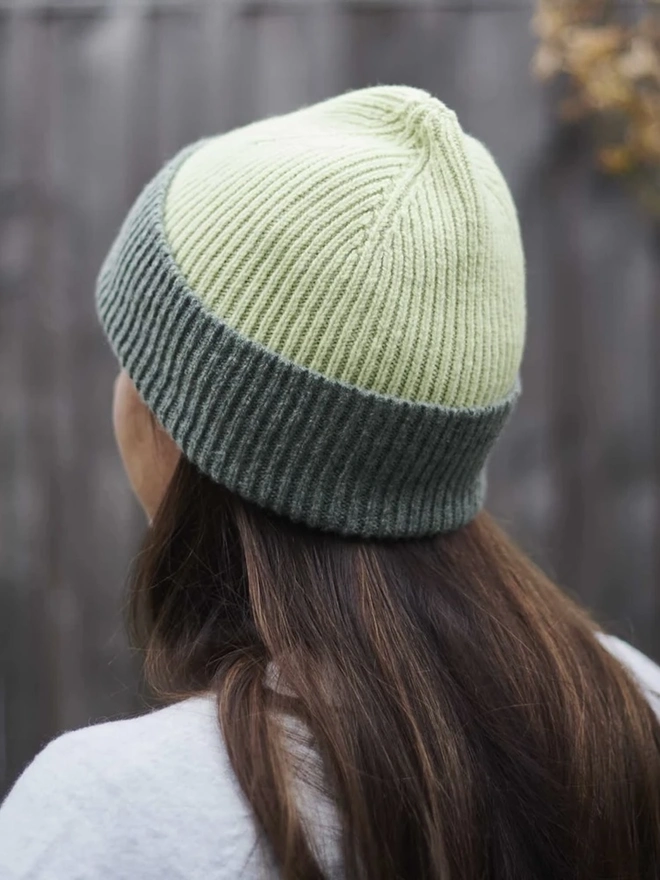 Ribbed Lambswool Women's Beanie, a woman wearing a colourful beanie outdoors. 