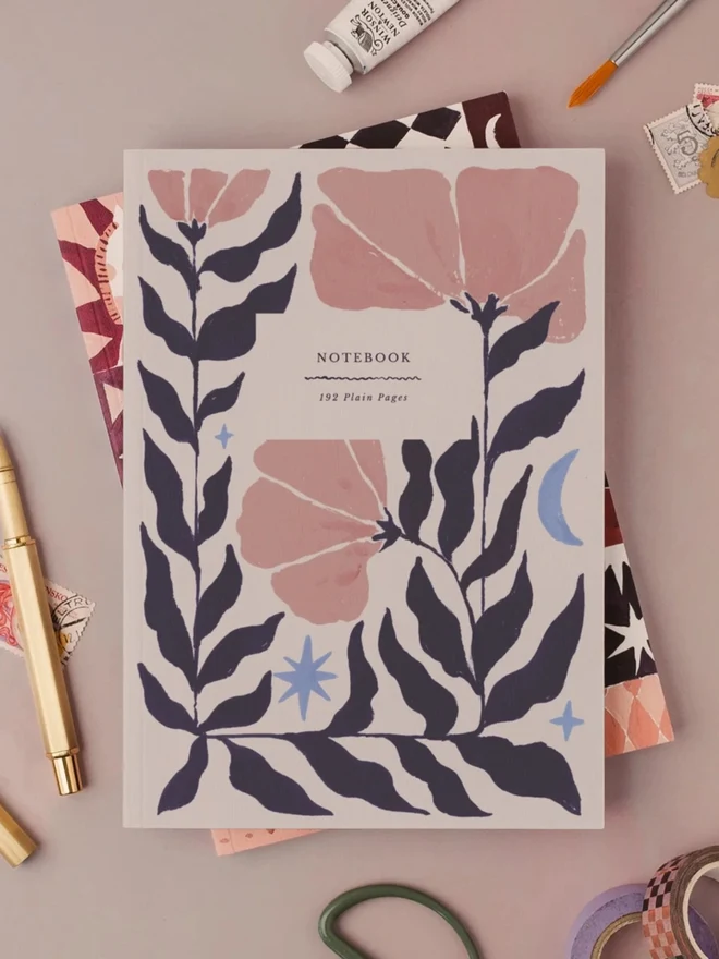 Botanical Notebook with a gold pen and art supplies