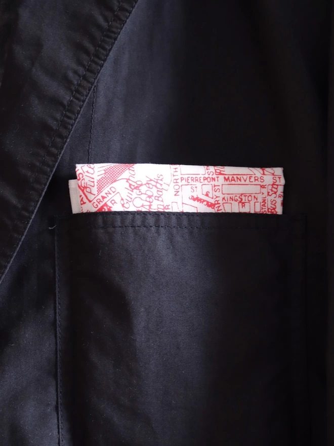 A Mr.PS Bath map hankie tucked in the top pocket of a dark blue jacket