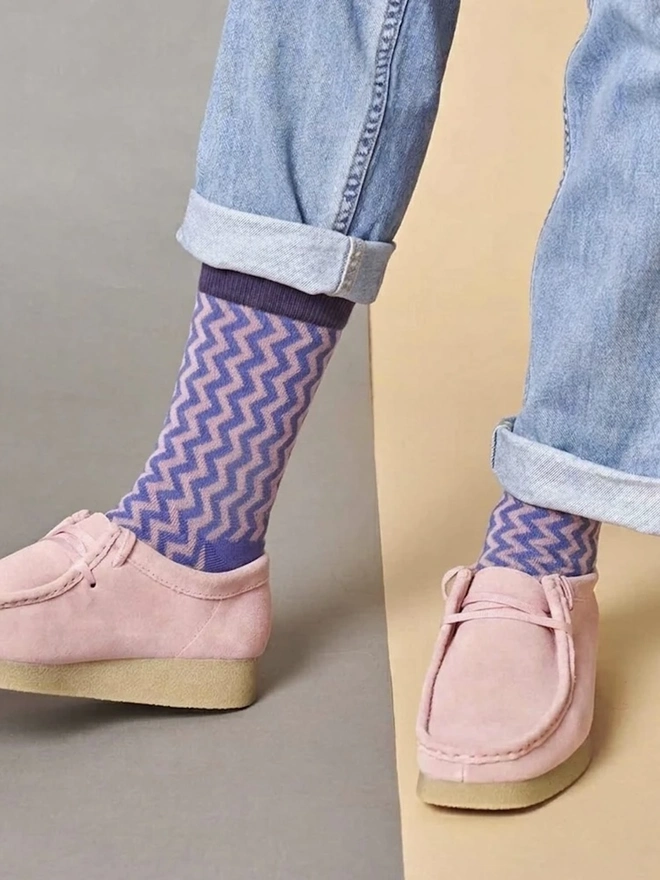 Women's Organic Cotton Ankle Socks Packs (Sets Of 3), a person wearing a pair of colourful patterned socks. 
