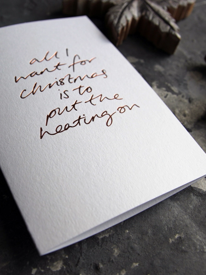 want to put the heating on white christmas card metallic script