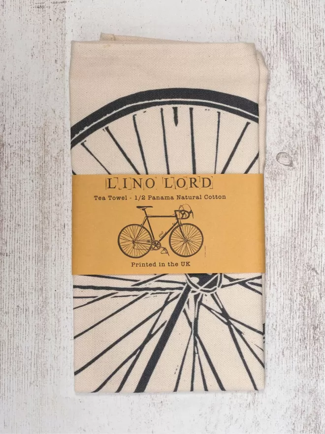 Picture of a tea towel with an image of a Bicycle, taken from an original lino print