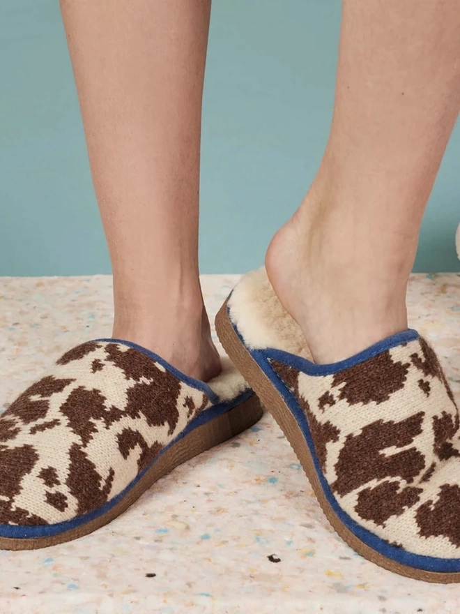Women's Lambswool & Sheepskin Slippers, a person wearing a pair of colourful slippers indoors. 