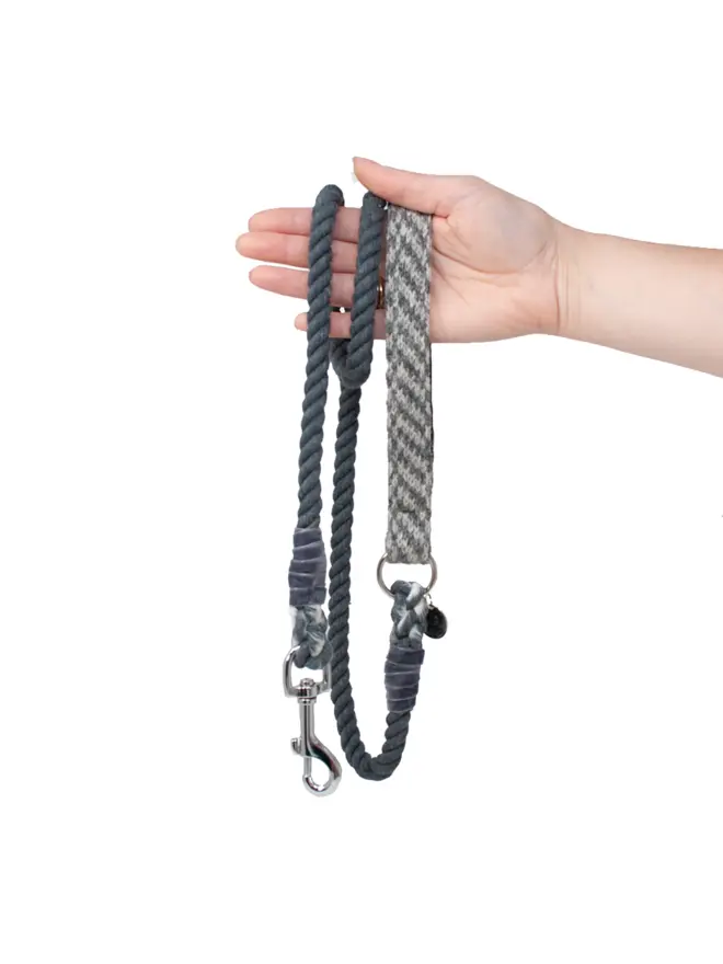 grey rope dog lead held in hand on white background