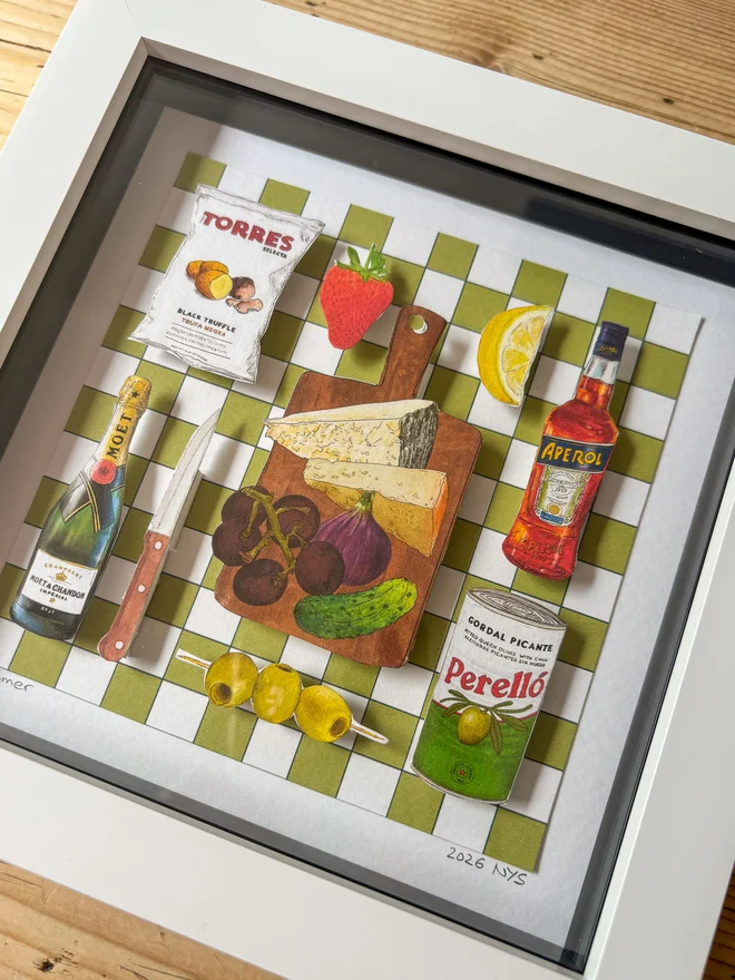 Close-Up of 3D paper collage showing a summer picnic spread on a green and white backdrop