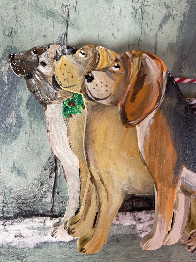 A range of pet portrait decorations lined up - a spaniel, border terrier, labrador and beagle 