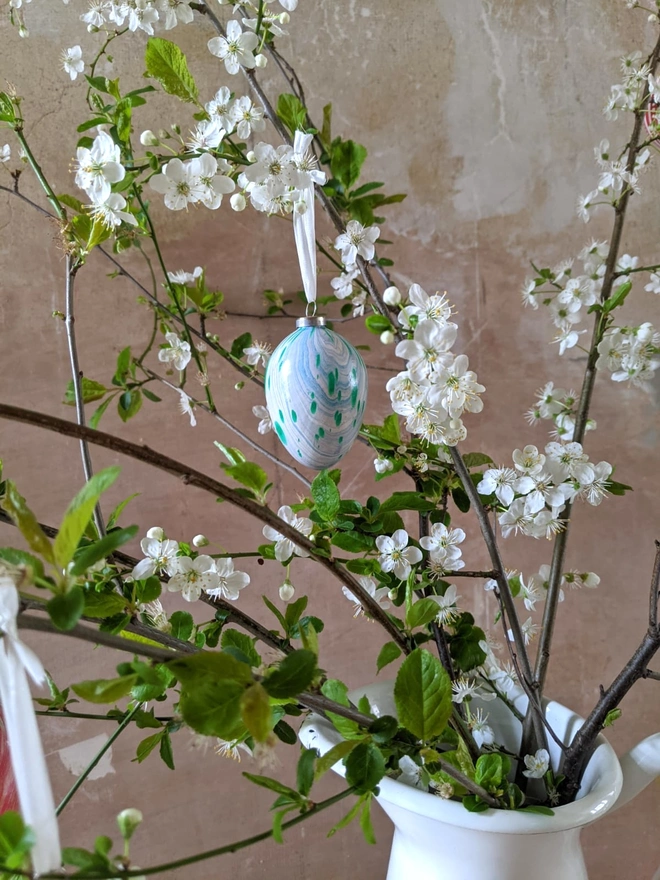 Hand-marbled hanging easter egg decoration on easter twig