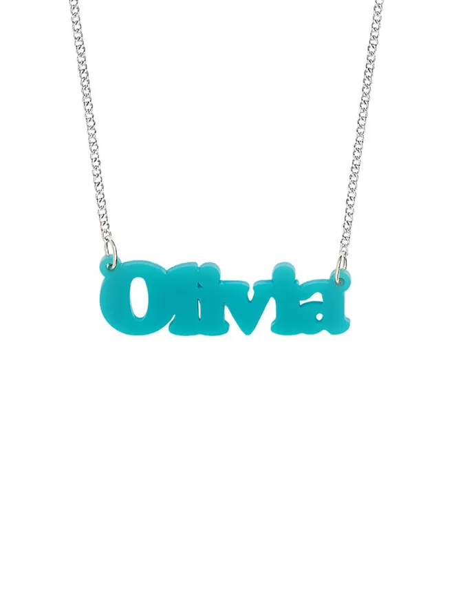 Personalised Name Neckace from Tatty Devine. The Necklace is the word Olivia laser cut from Turquoise Acrylic on a silver-plated chain.