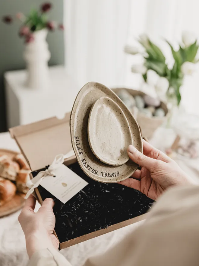 Set of two egg shaped speckled plates