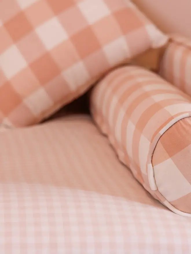 'the posie' pink gingham upholstered children's bed. a pink gingham sofa-style bed, with a close up shot of a matching cushion.