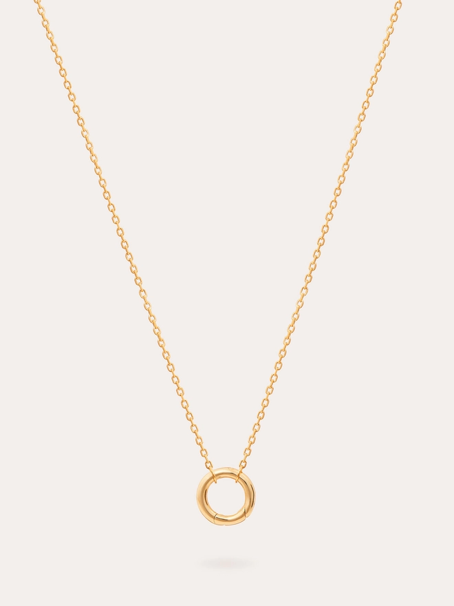 still life image of a single link fine chain gold necklace