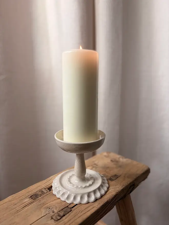 Pillar Candle Holder with Candle on wooden stool