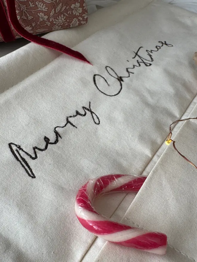 Embroidered Advent calendar. Close up stitched Merry Christmas 