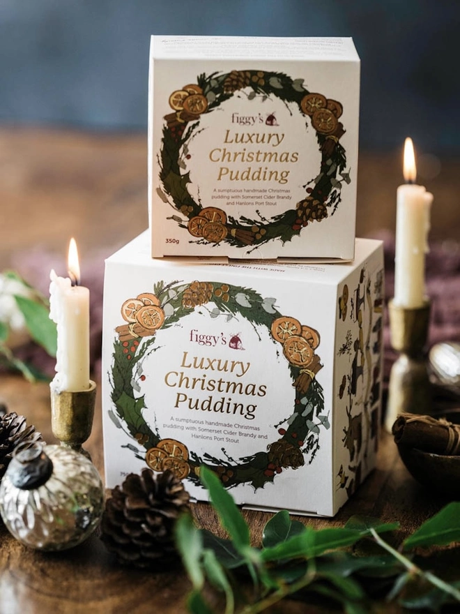 Luxury, Handmade Christmas Pudding, a pair of Christmas pudding boxes sitting on a wooden surface. 
