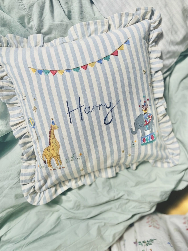 Hand Painted Giragge and ELephant celebrating the joy of the circus. Blue striped ruffle cushion with hand embroidered personalised name in the centre