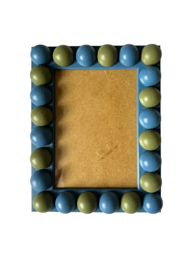 blue and green wood bobbin frame