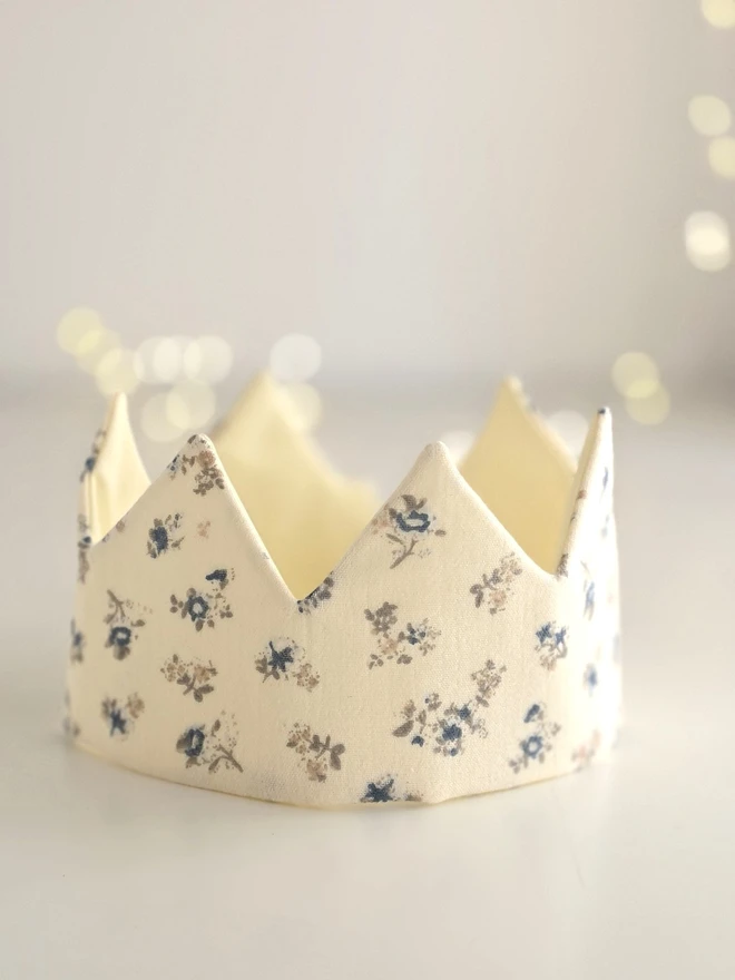 Handmade fabric birthday crown in soft vanilla cotton with delicate blue ditsy floral print from the Mabel Vintage Blue Floral Collection.