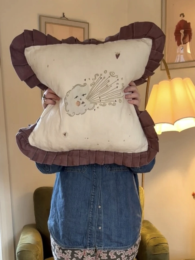 'Love Cloud' Linen Ruffled Cushion Cover, a person holding a cushion cover with a cloud motif on it. 