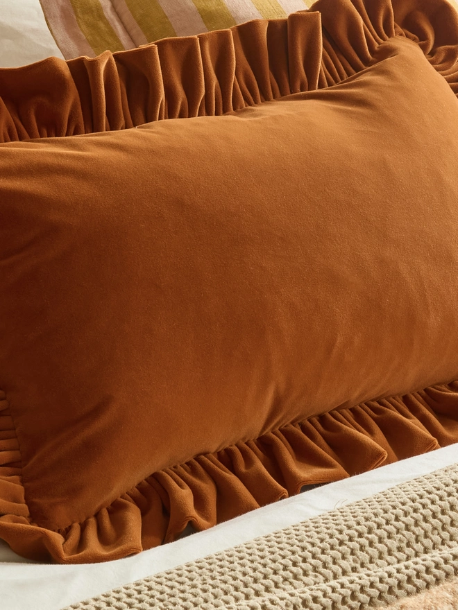 Kika Bespoke ruffled velvet cushion ruffle detail in rust,