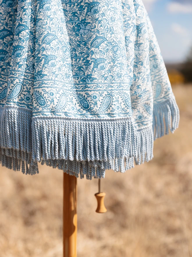 Indian Block Print Parasol. A close up of a blue and white parasol 