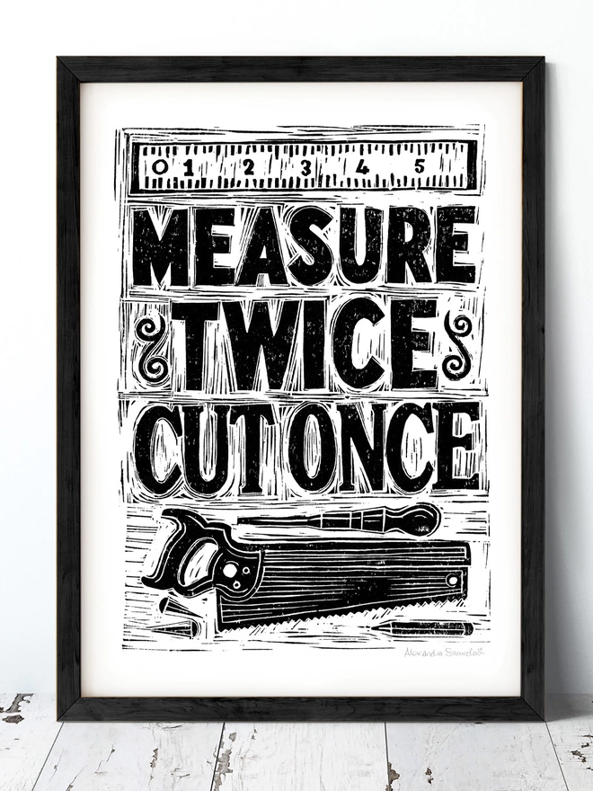 measure twice cut once woodworking print in black and white with black frame