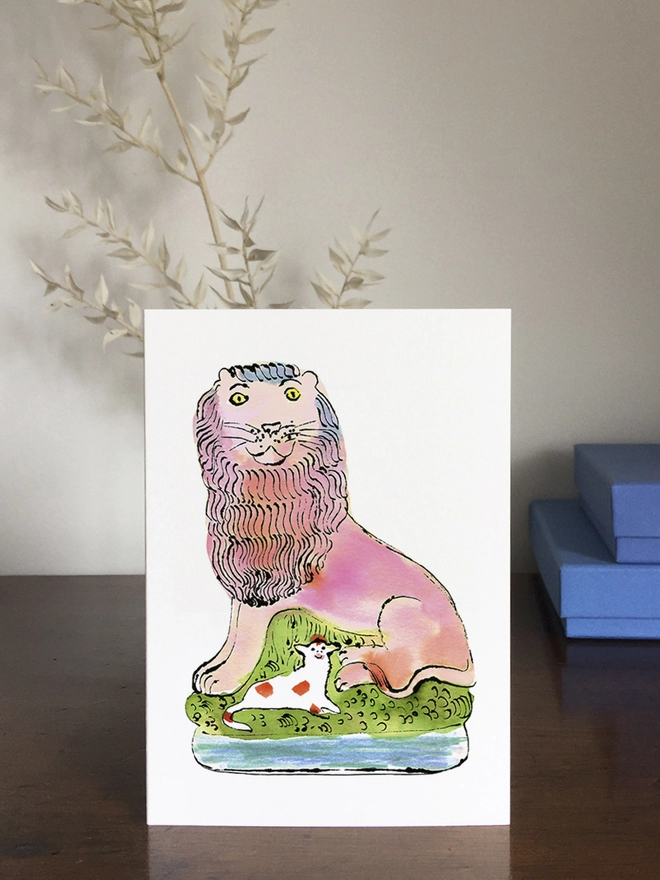 A greeting card featuring a lion and a lamb