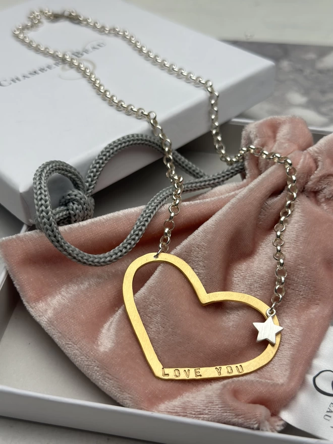 Large personalised gold open heart charm on a sterling silver chain, with a small silver star charm beside the heart