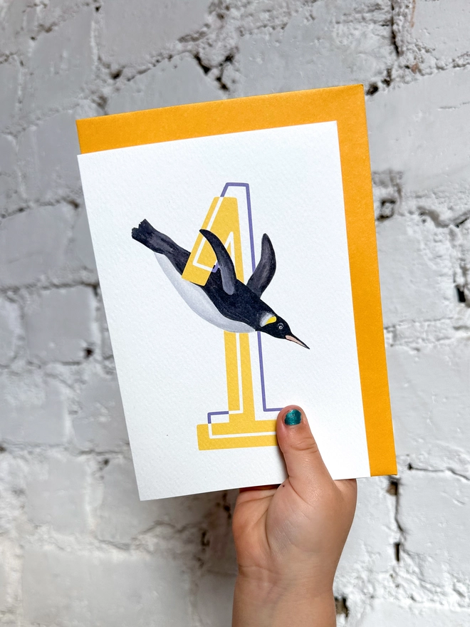 a white card with a big yellow number 1 and illustrated penguin with a bright yellow envelope
