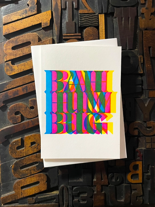 Bah Humbug! A beautiful typographic letterpress Christmas card set. Printed with rich vibrant and fluorescent blue, magenta and yellow inks with luxury matching and contrasting envelopes; ideal to send to your designer friends.