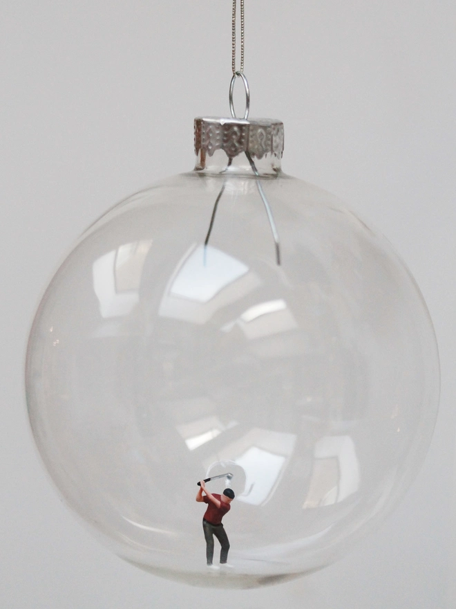 Miniature figure of a make golfer in a glass hanging christmas bauble 