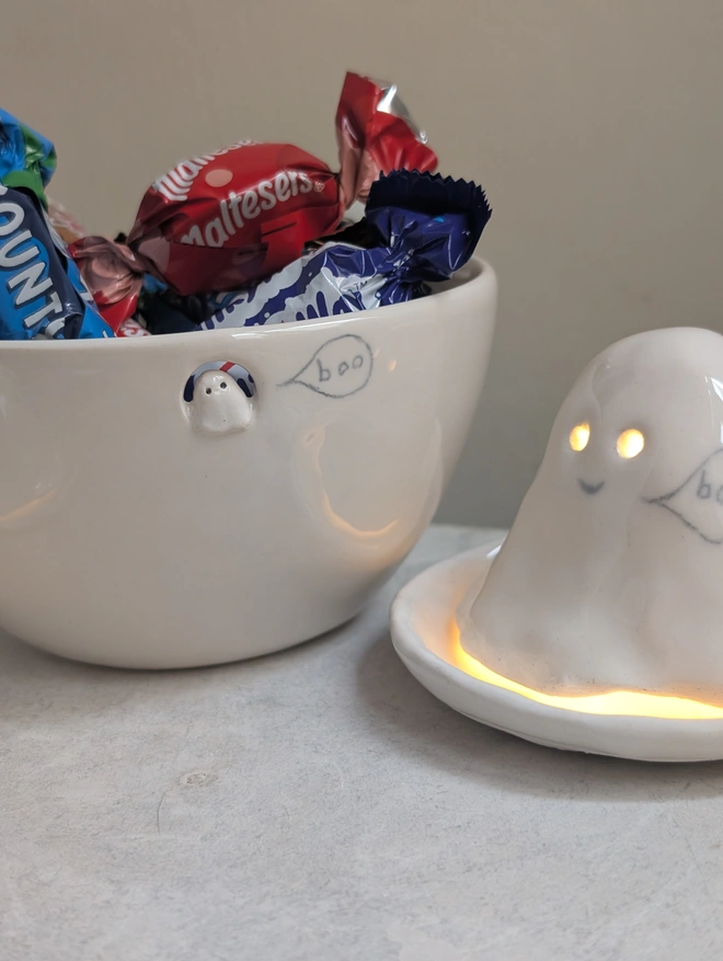 white ceramic bowl filled with chocolate and Halloween ghost tealight with tiny whimsical ghost 