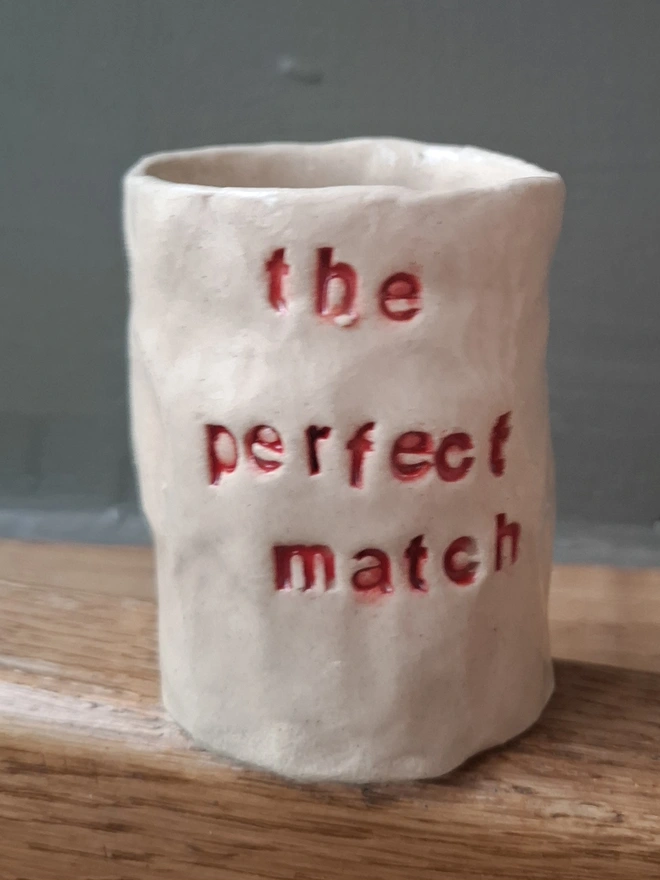 Ceramic Match Holder with the phrase 'the perfect match' stamped into it 