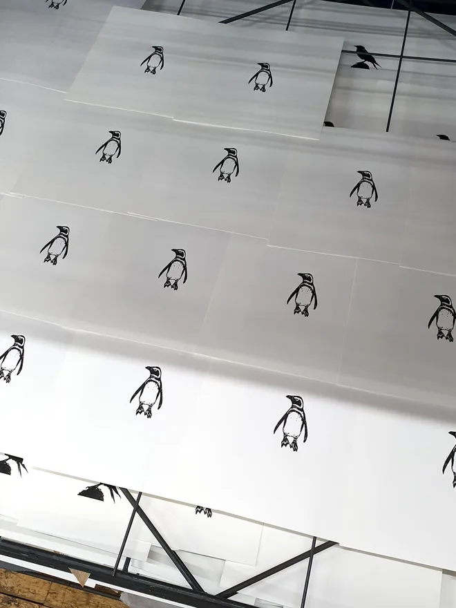 Penguin wood engraving prints on drying rack