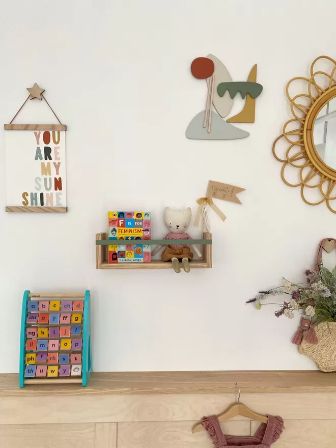 Solid wood bookshelf in a colourful kids room filled with fun kids decor