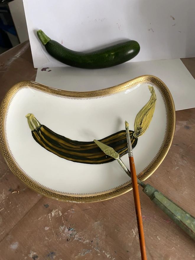 painting a fresh courgette in the studio