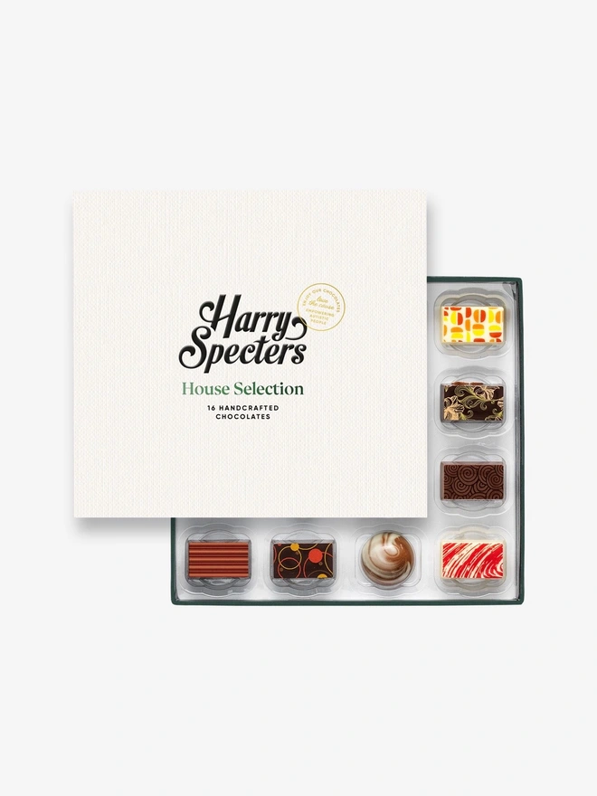 A box of 16 chocolate partially covered by a Harry Specters lid