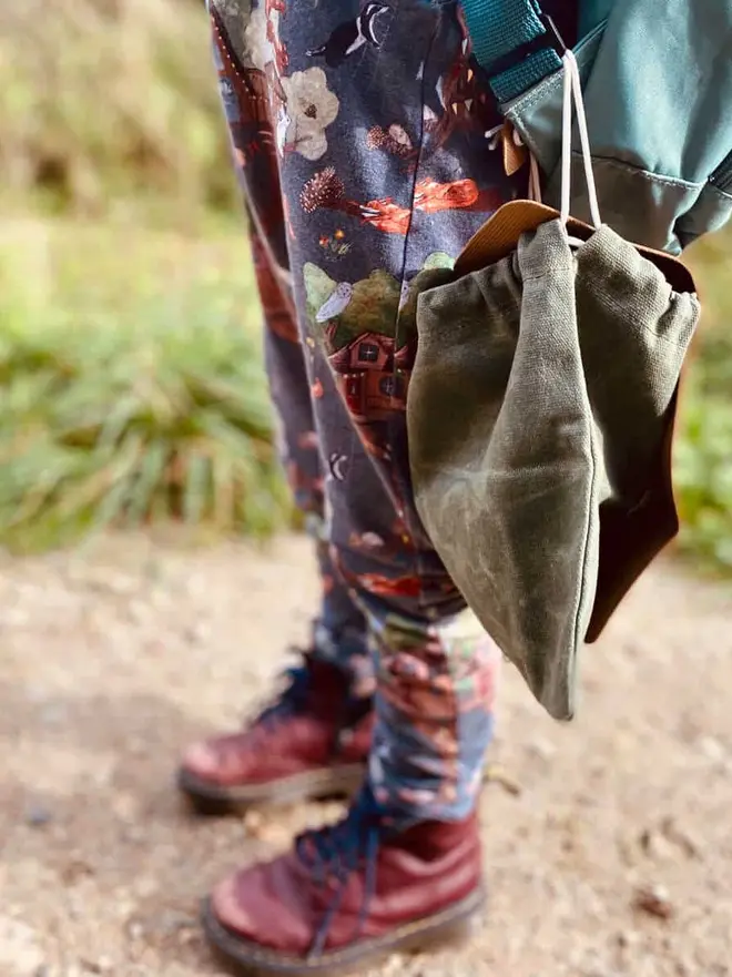 Personalised Foraging Drawstring Canvas Pouch, hanging on a bag. 