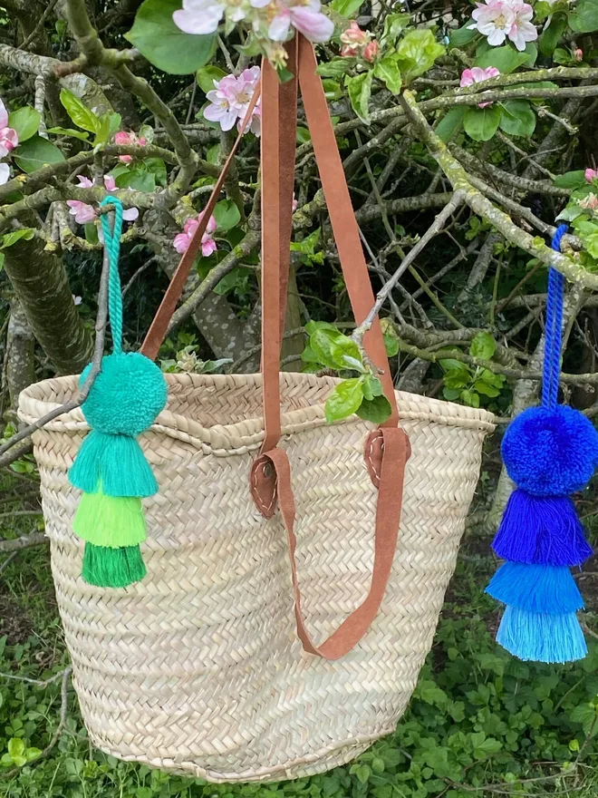 pom pom and tassel swag hanging decoration. hanging decorations in shades of blue and green.
