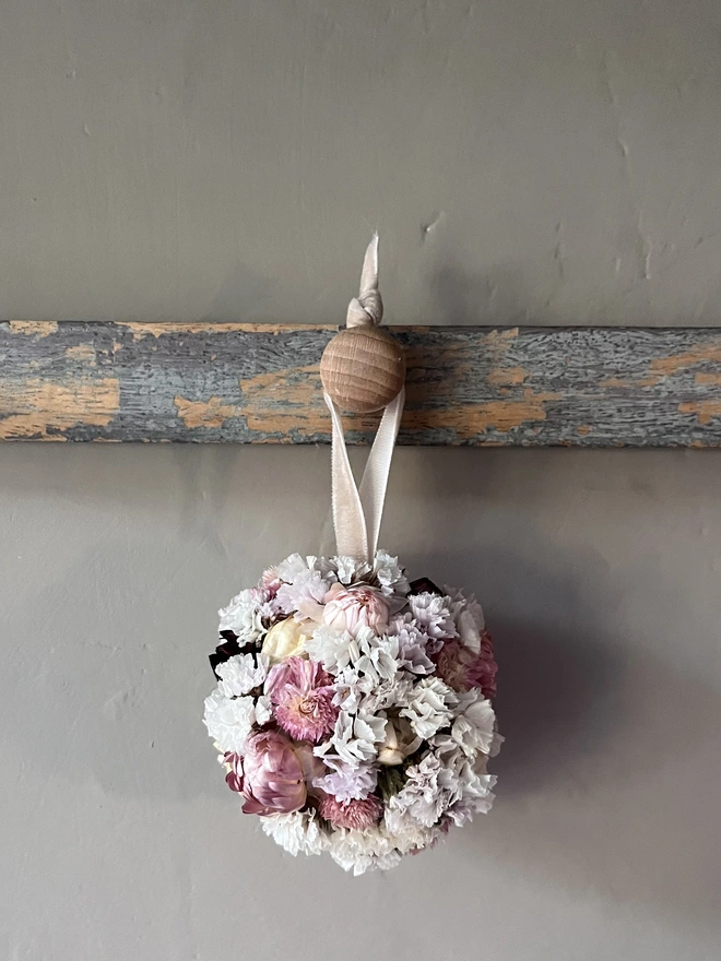 Pink and white dried flower bauble made using a selection of seasonal blooms. 